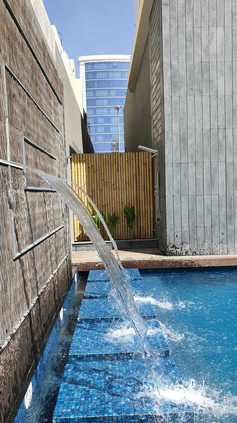 Water spouts pouring into a private villa pool